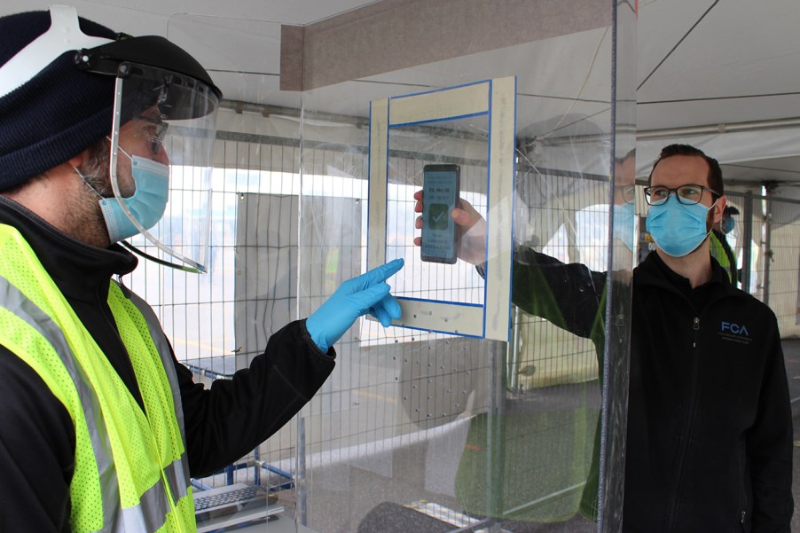 Autoworker employee going through a health screening at a Stellantis plant. Recently Stellantis set a vaccine mandate for all U.S. non-union employees