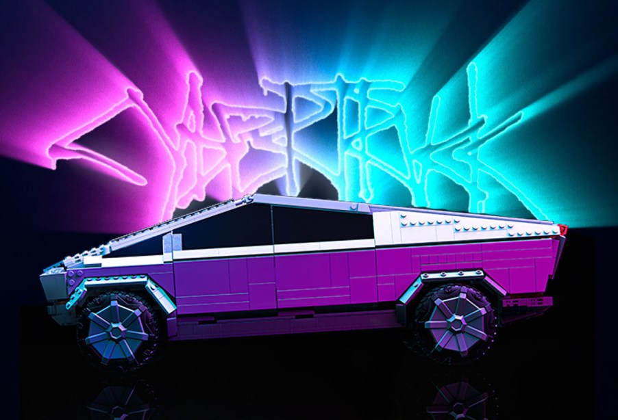 Tesla Cybertruck MEGA block set with the glowing Cybertruck logo behind it