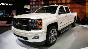 A white Chevrolet Silverado is on display.