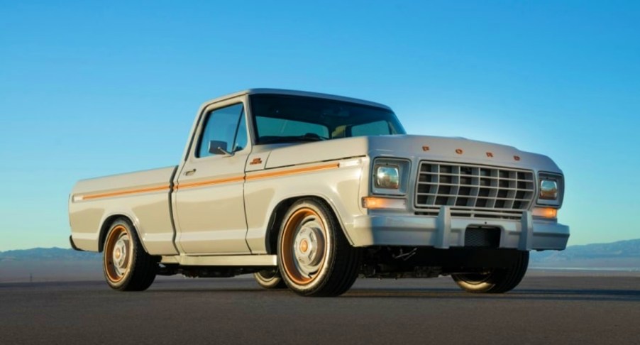 A white Ford F-100 concept truck is on display.