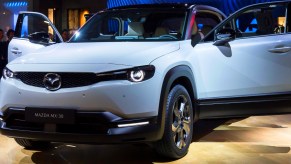 A gray Mazda MX-30 electric SUV is on display.