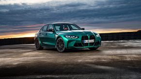 An Isle of Man green BMW M3 shot from the front 3/4 at sunset