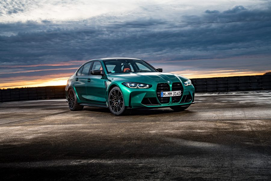 An Isle of Man green BMW M3 shot from the front 3/4 at sunset