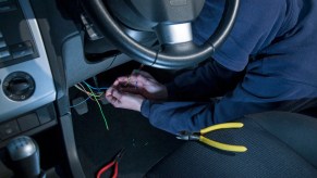 Man doing electrical work on a car