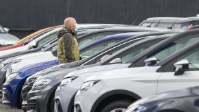 Man walks through car dealership looking for the most satisfying car brand 2021