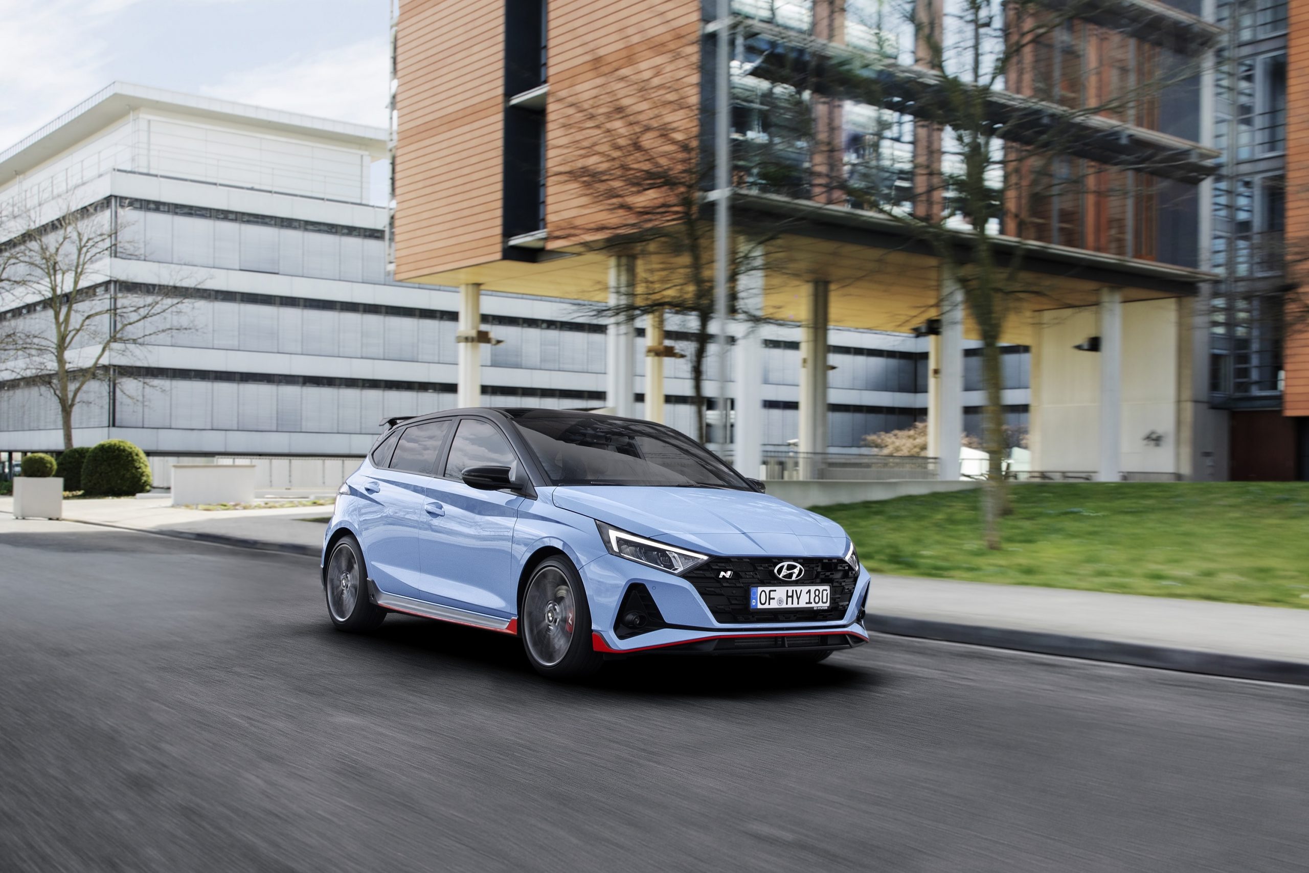 A blue Hyundai i20N shot from the front 3/4 on a city street