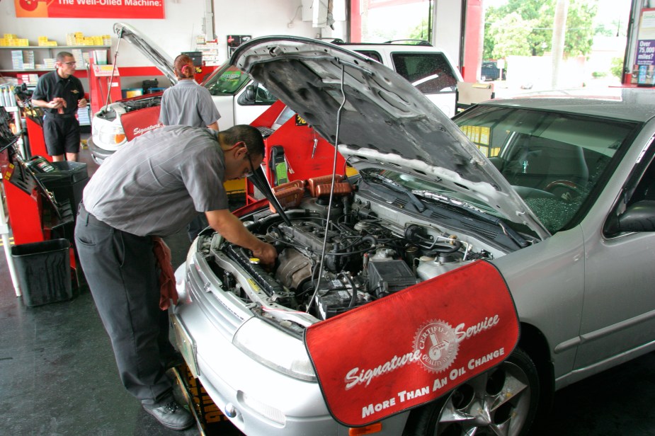 A jiffy lube mechanic changes the oil on a car. But, some truck brands offer complimentary maintenance like this. 