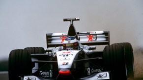 Mika Hakkinen racing his McLaren MP4-13 at Silverstone