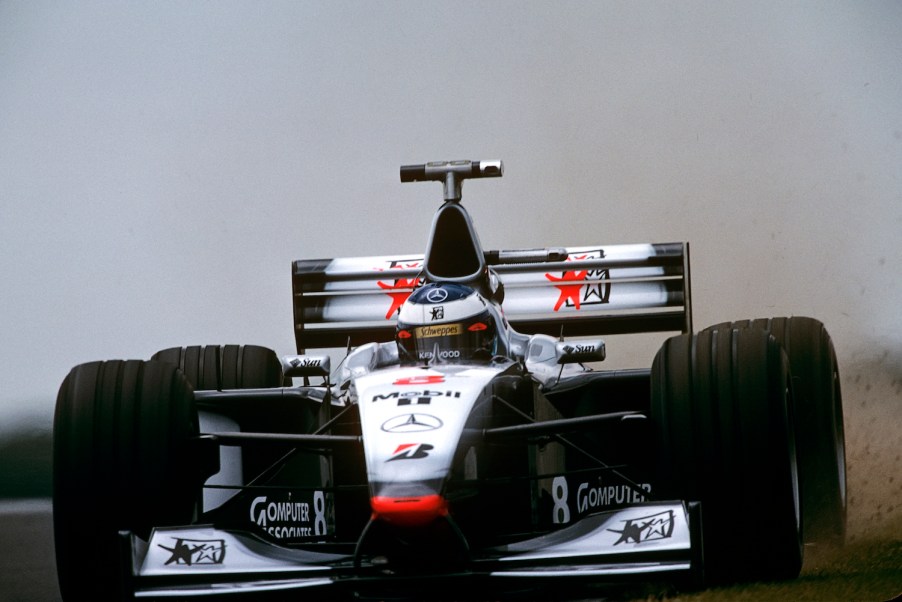 Mika Hakkinen racing his McLaren MP4-13 at Silverstone