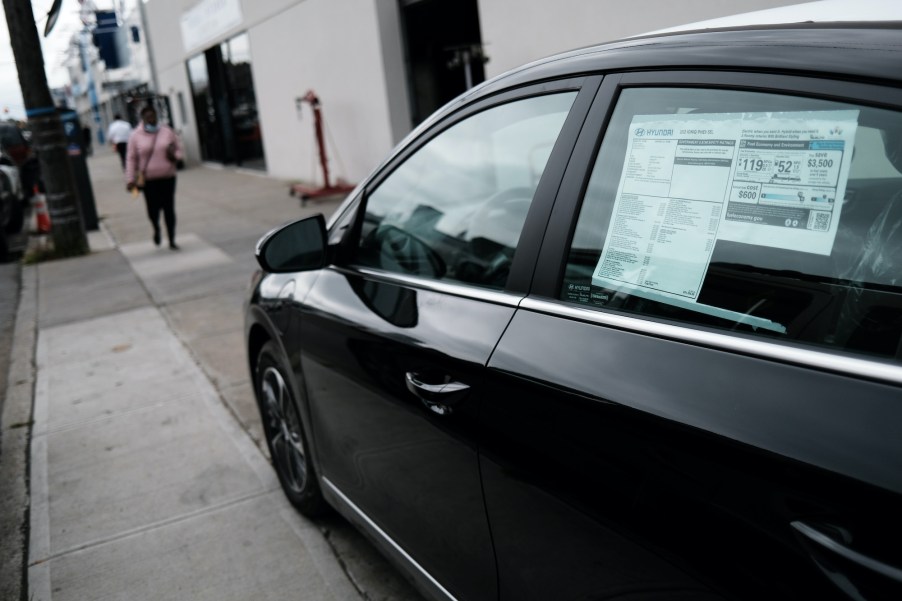 a new car sits outside a dealership