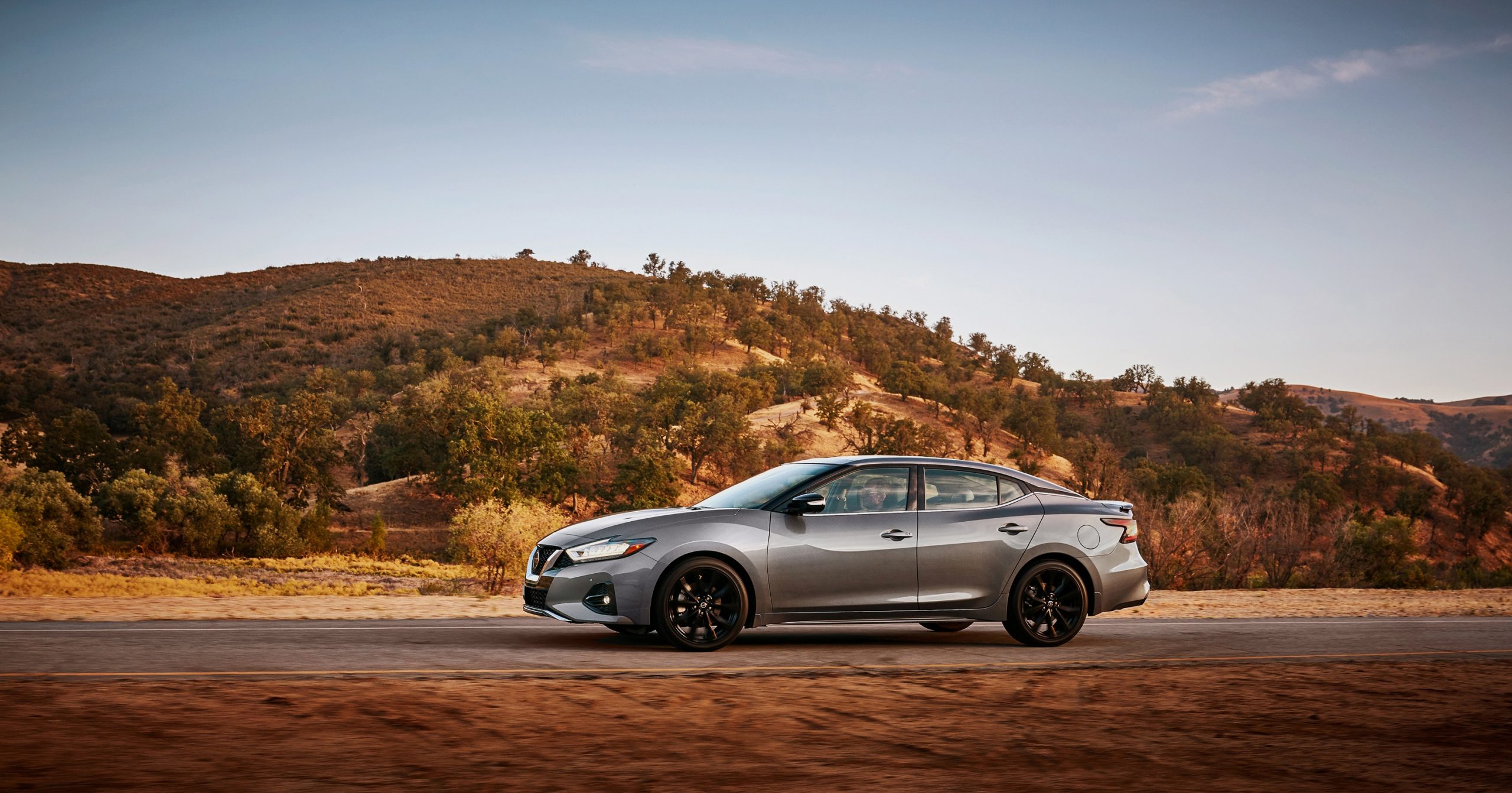 A silver 2022 Nissan Maxima shot in profile