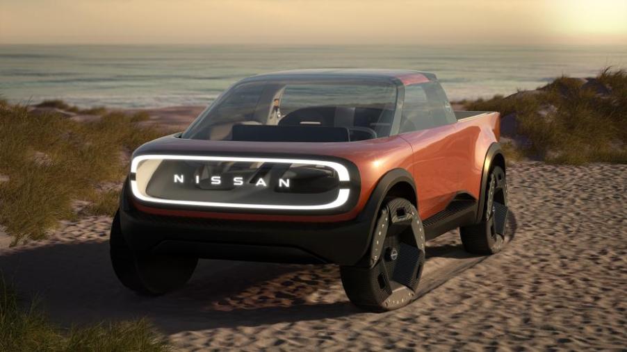 An orange futuristic-looking truck on the beach.