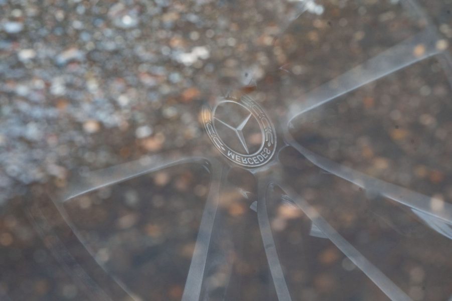 Mercedes Star reflected in a puddle