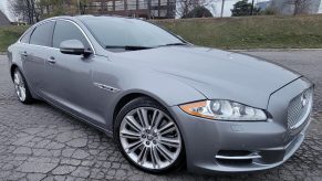 The front 3/4 view of a gray 2011 Jaguar XJ Supercharged in a parking lot