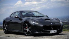 A black 2012 Maserati GranTurismo MC Stradale on a mountain road