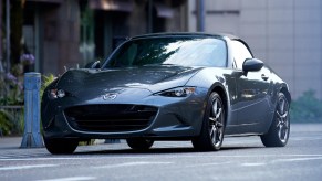 A gray 2021 Mazda MX-5 Miata on a city street