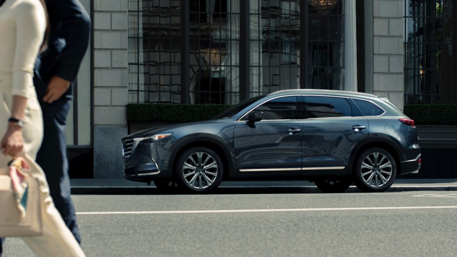 A blue 2021 Mazda CX-9 parked outside of a business.