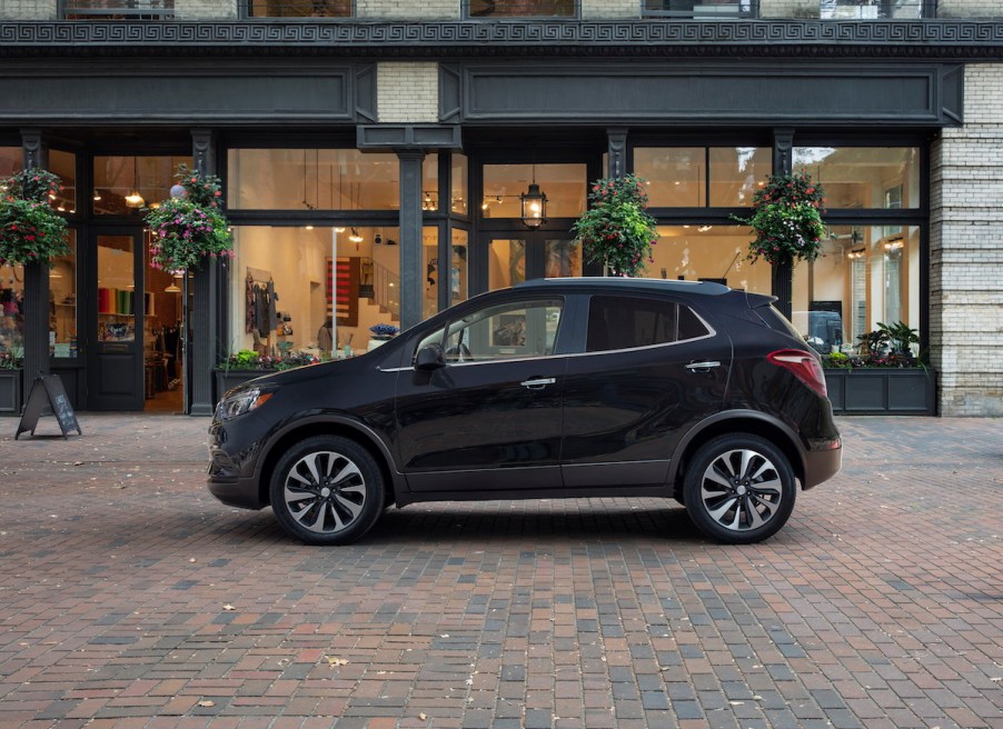 A black 2022 Buick Encore premium subcompact SUV parked outside a storefront