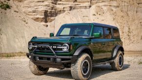 A 2022 Ford Bronco four-door midsize SUV in Eruption Green parked in desert terrain