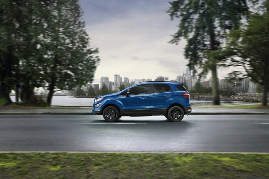 A blue 2022 Ford EcoSport driving on a road with trees in the background, this SUV died in 2021.