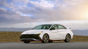 A white 2022 Hyundai Elantra N shot from the front 3/4 at sunset