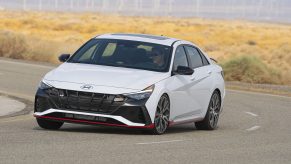 A white 2022 Hyundai Elantra N sedan shot from the front 3/4