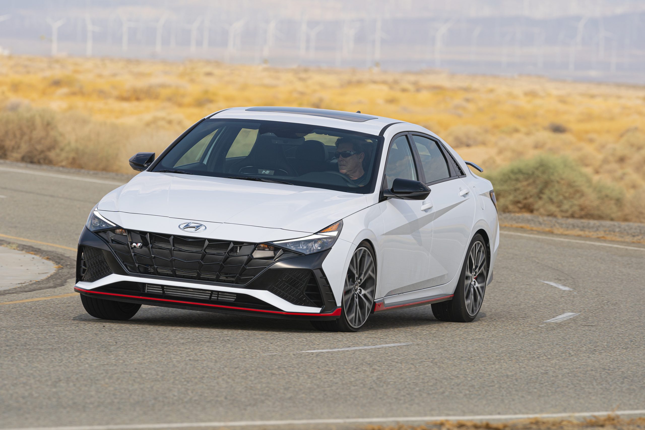 A white 2022 Hyundai Elantra N sedan shot from the front 3/4