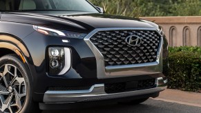 Black 2022 Hyundai Palisade parked on the side of a road