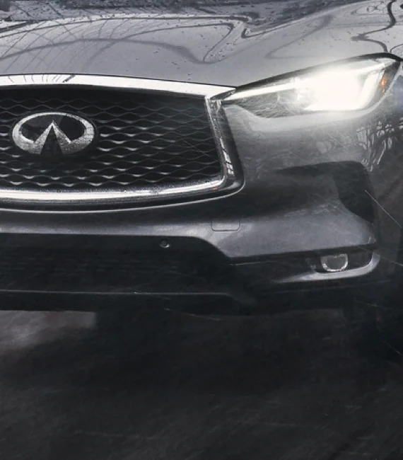 A gray 2022 Infiniti QX50 crossover frot end with LED headlights, it gained new tech for the new model year.