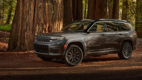 A 2022 Jeep Grand Cherokee L midsize crossover SUV parked in the middle of a forest