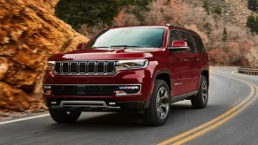 A red 2022 Jeep Wagoneer is driving on the road.