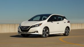 A white Nissan Leaf EV hatchback shot from the front 3/4