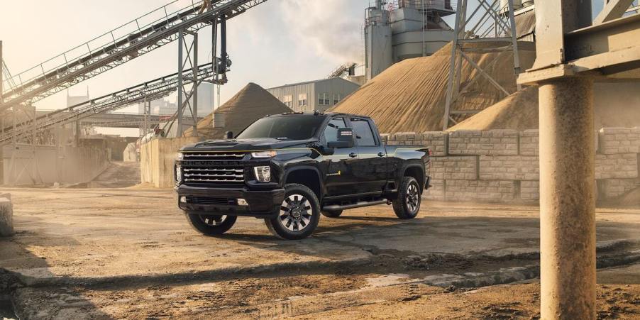 A black 2022 Chevy Silverado 2500 HD heavy-duty pickup truck parked on a construction site.