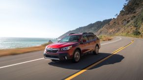 A red Subaru Outback crossover shot from the front 3/4