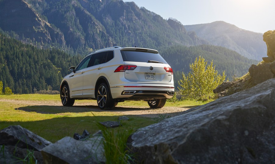 A white 2022 Volkswagen Tiguan sits on grass with a mountainous background, what is the release date, price, and specs for the SUV?