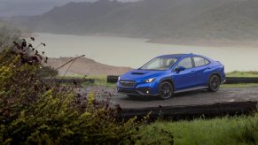 A rally blue 2022 Subaru WRX AWD sedan shot on a rainy day