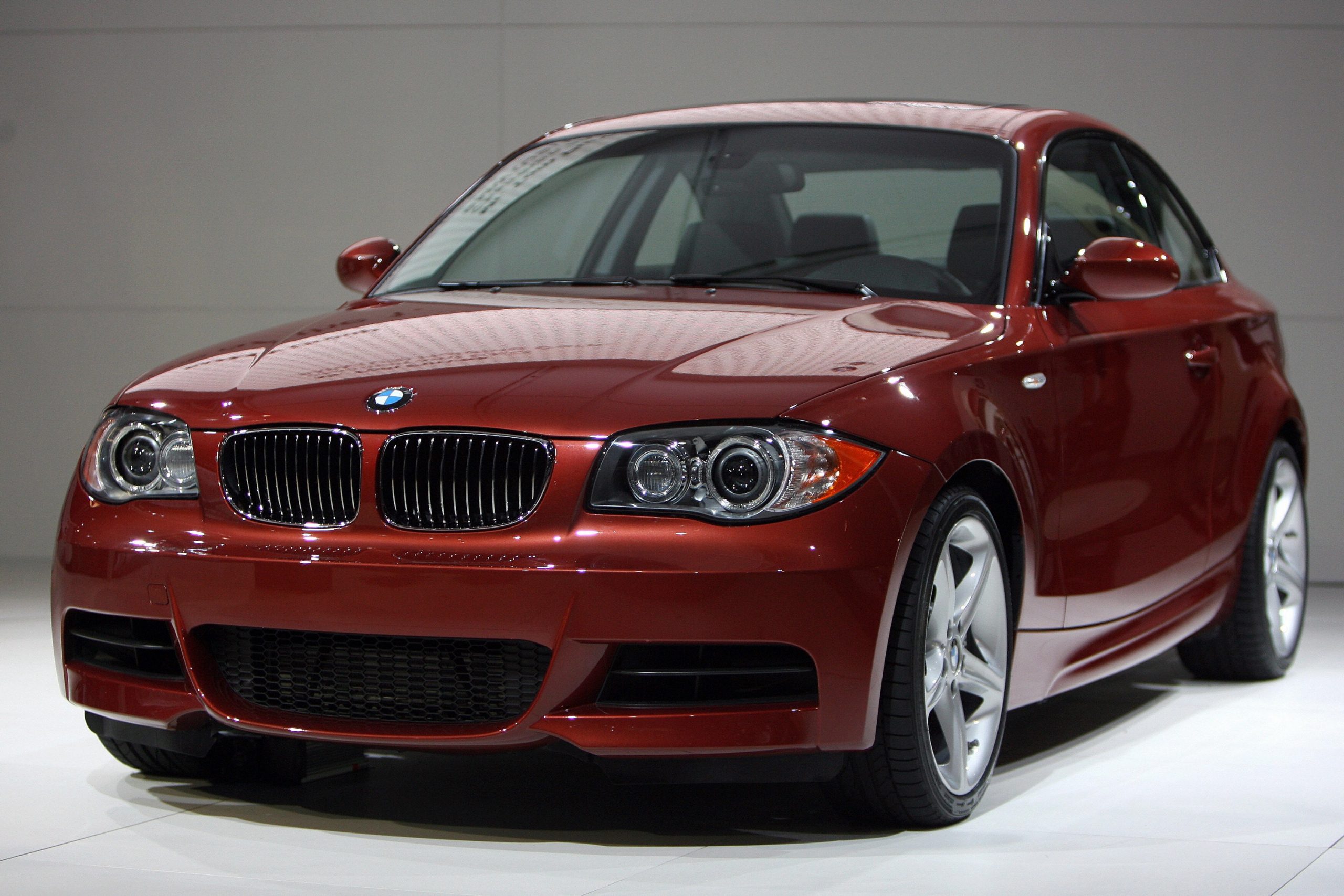 A BMW 135i coupe shot from the front 3/4  at an auto show