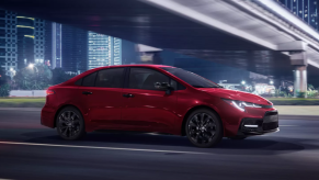 Barcelona Red Metallic 2022 Toyota Corolla driving under a bridge