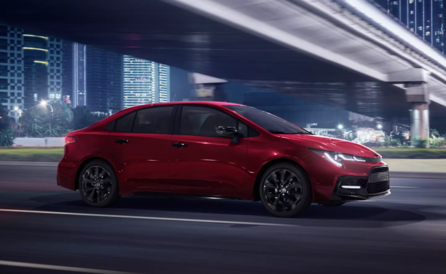 Barcelona Red Metallic 2022 Toyota Corolla driving under a bridge