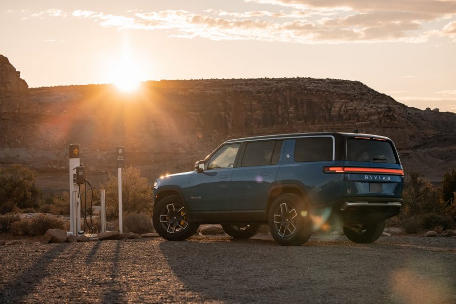 Blue 2022 Rivian R1S electric SUV parked at an EV charging station