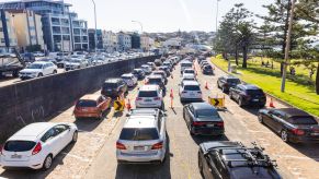 Many cars driving on a car possibly using various fuel sources.