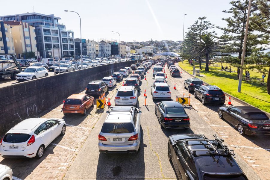 Many cars driving on a car possibly using various fuel sources.