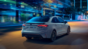 Celestite Gray Metallic 2022 Toyota Corolla driving on a street at night