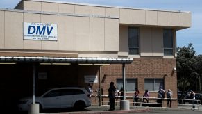 People waiting in line at the DMV. Make sure you research how to replace a lost car title before waiting in line.