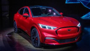 A red 2022 Ford Mustang Mach-E electric SUV is on display.