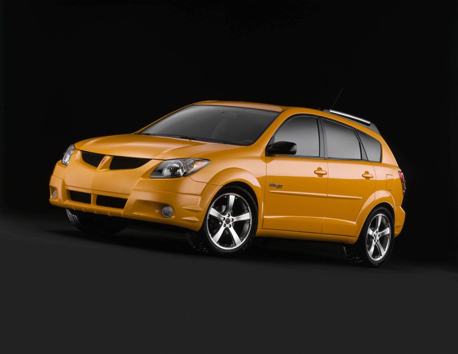 orange Pontiac Vibe against a black background. This is one of the best affordable cars you can buy under $5,000