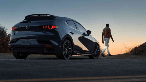 Gray 2022 Mazda3 Hatchback parked on the side of the road with the sunset in the background