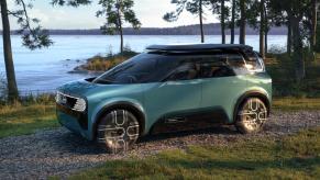 A green Nissan Hang-Out in front of the beach.