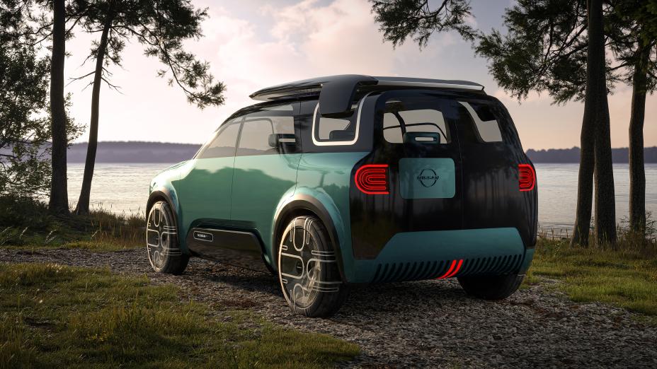 A green Nissan Hang-Out in front of the beach.