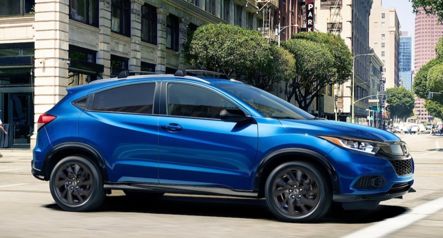 A blue 2022 Honda HR-V driving through a city.